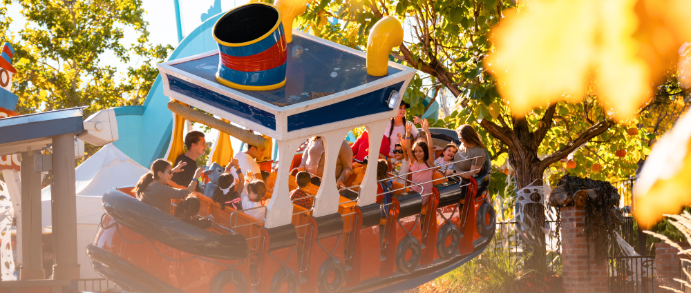 fall-fun-kids-on-ride Father and son riding a roller coaster together